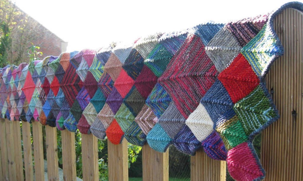 Long mosaic scarf on the fence
