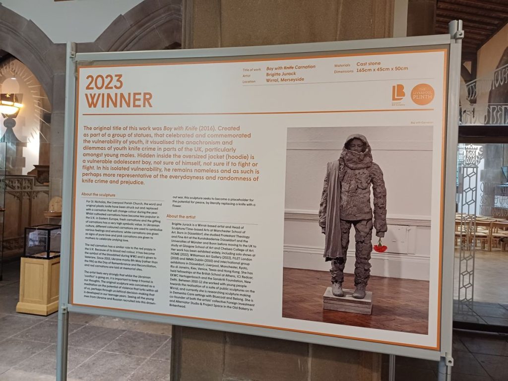Picture shows a display board describing the 2023 Winner of the art competition.