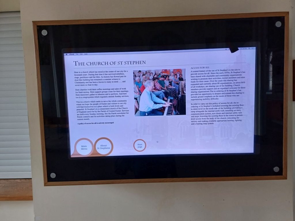 Image shows a flat screen tv with information about the Parish of St Stephen in Exeter. 